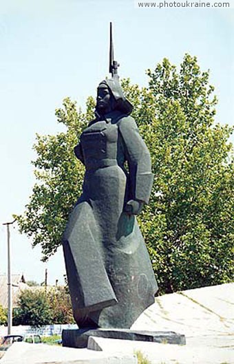 Town Kakhovka. Monument Girl in greatcoat Kherson Region Ukraine photos