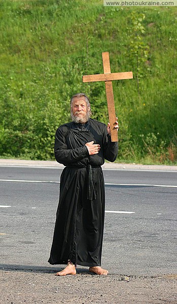 Barefoot pilgrim on road at Mount Grey Kichera Zakarpattia Region Ukraine photos