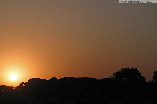 Terpinnia. Sunset silhouette of Stone Grave Zaporizhzhia Region Ukraine photos