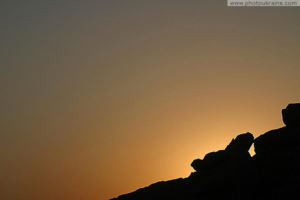 Terpinnia. Sunset silhouette of slope of Stone Grave Zaporizhzhia Region Ukraine photos