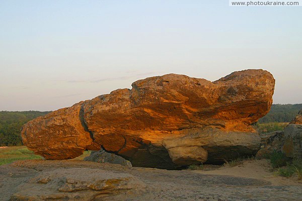 Terpinnia. Whimsically painted sun boulder Zaporizhzhia Region Ukraine photos