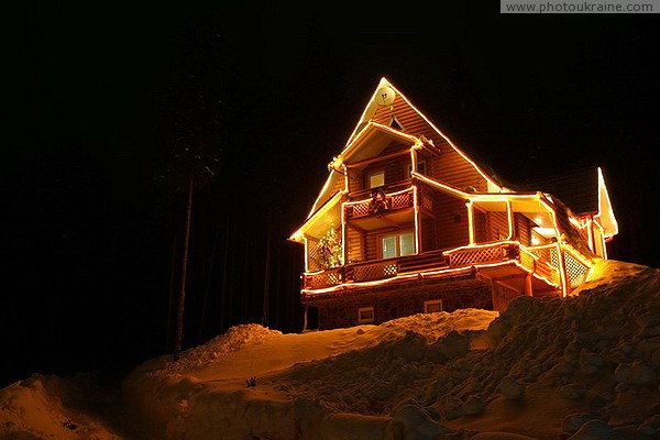 Bukovel. Light silhouette of a three-story cottage Ivano-Frankivsk Region Ukraine photos