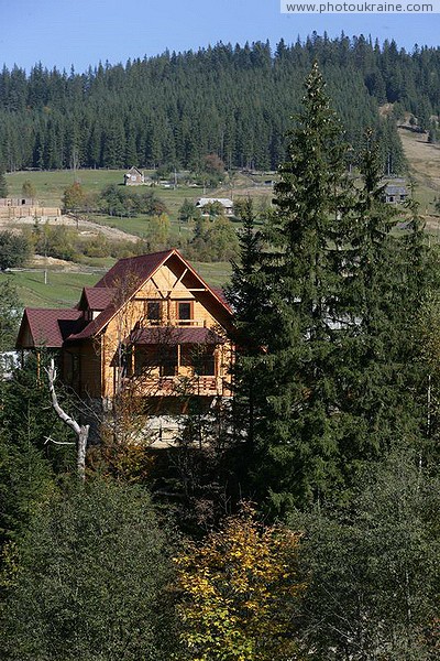 Vorokhta. Wooden cottage under beautiful spruce Ivano-Frankivsk Region Ukraine photos